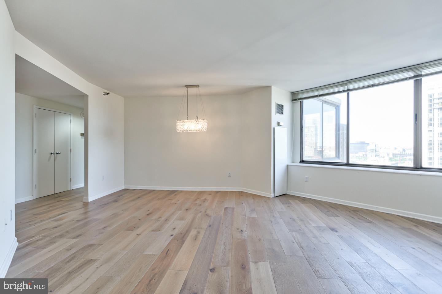 202-10 West Rittenhouse Square, Unit 1705 Philadelphia, PA 19103 - Photo 2 of 28 a view of an empty room with wooden floor and a window