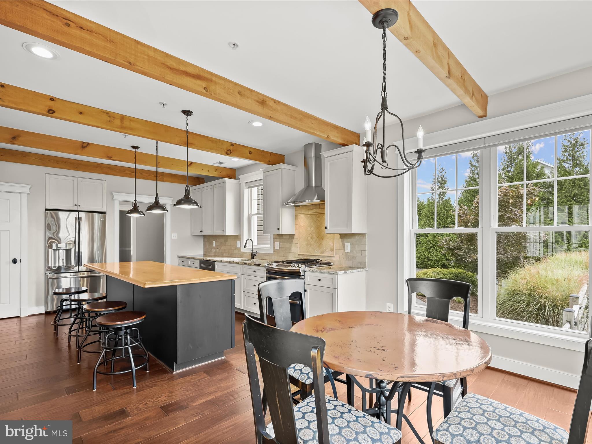 17263 Hardy Road Mount Airy, MD 21771 - Photo 25 of 98 a dining room with wooden floor a chandelier a wooden table and chairs