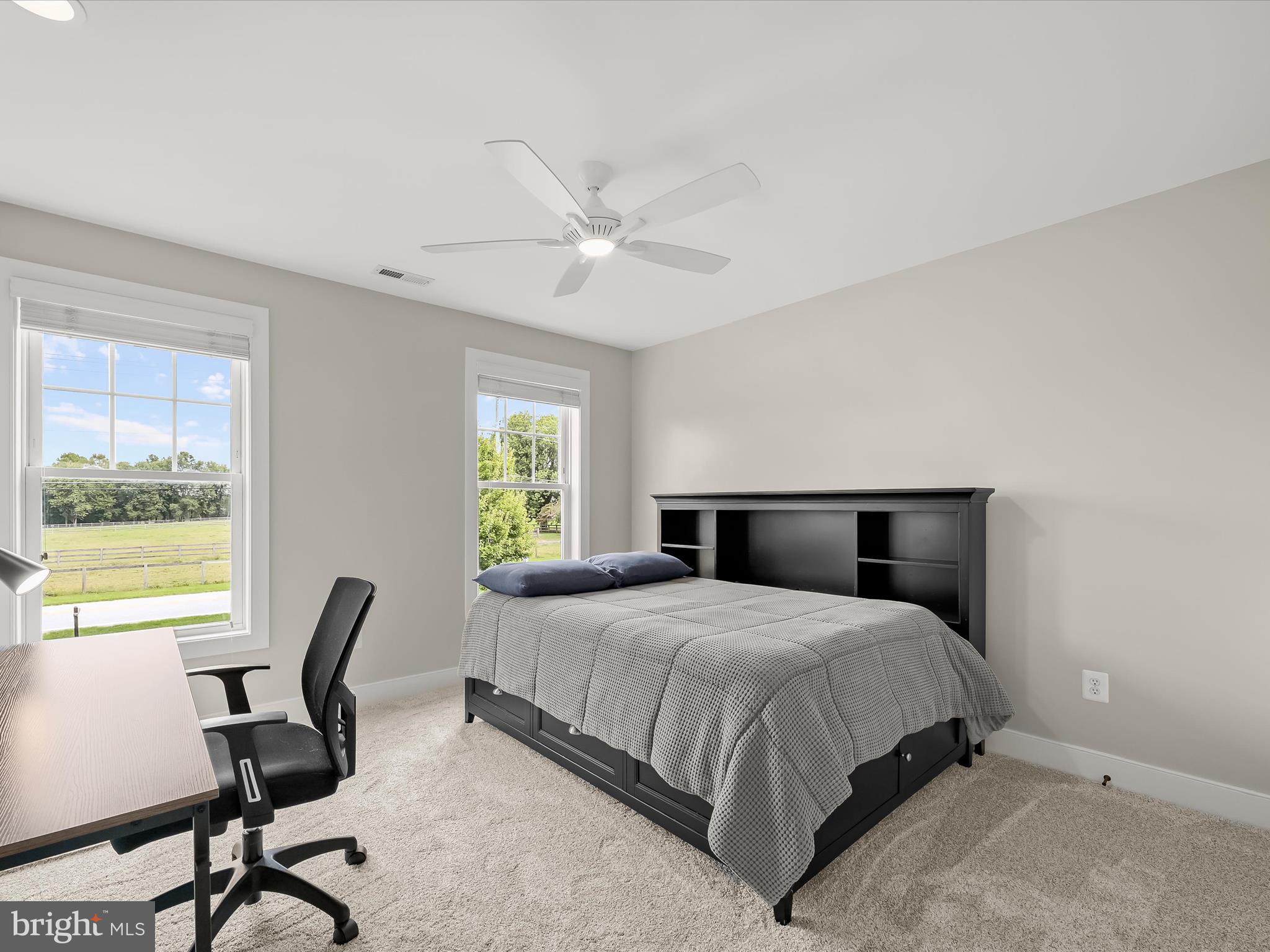 17263 Hardy Road Mount Airy, MD 21771 - Photo 48 of 98 a bedroom with a bed a chair and a large window
