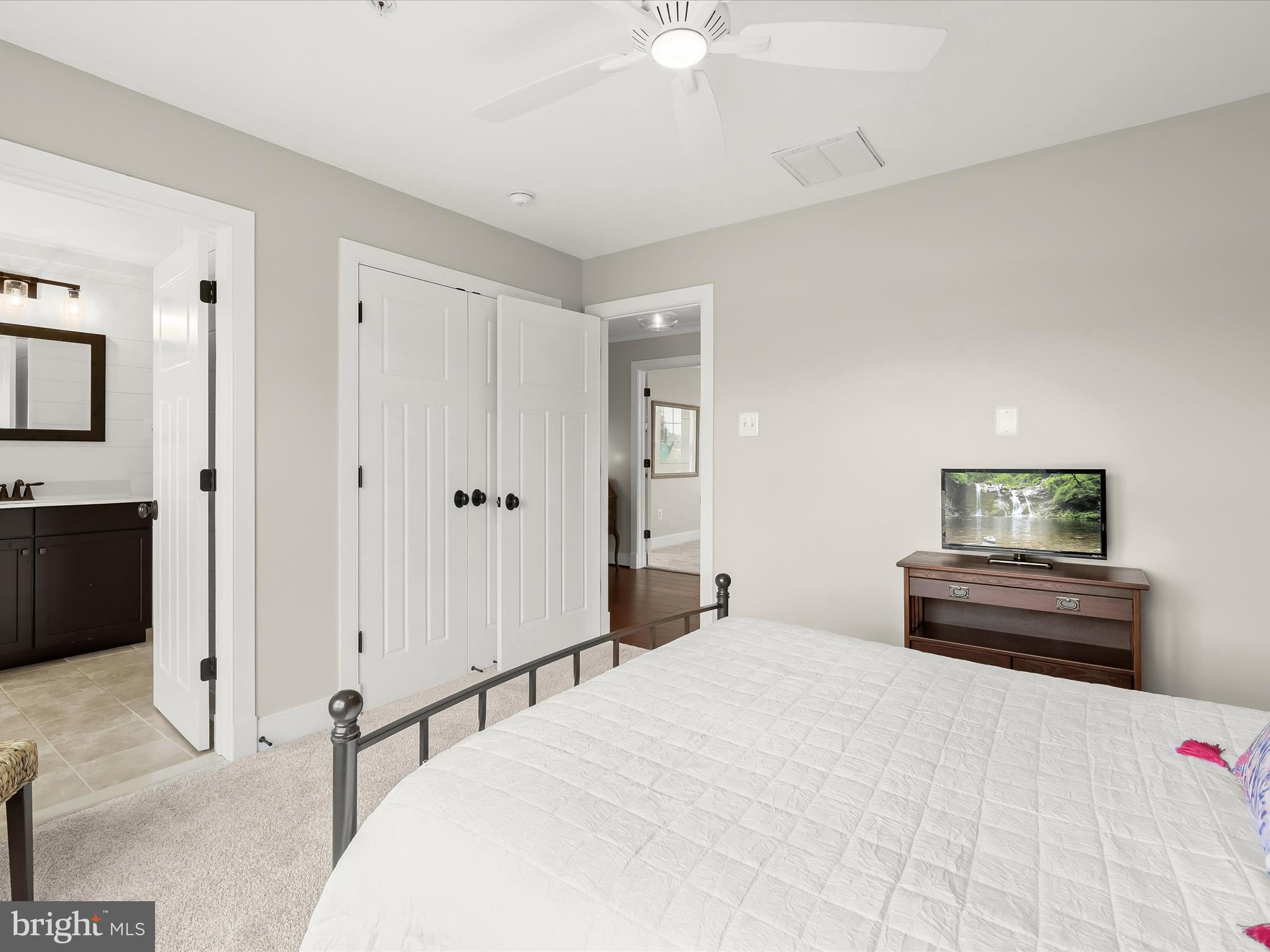 17263 Hardy Road Mount Airy, MD 21771 - Photo 53 of 98 a bedroom with a bed and a chandelier