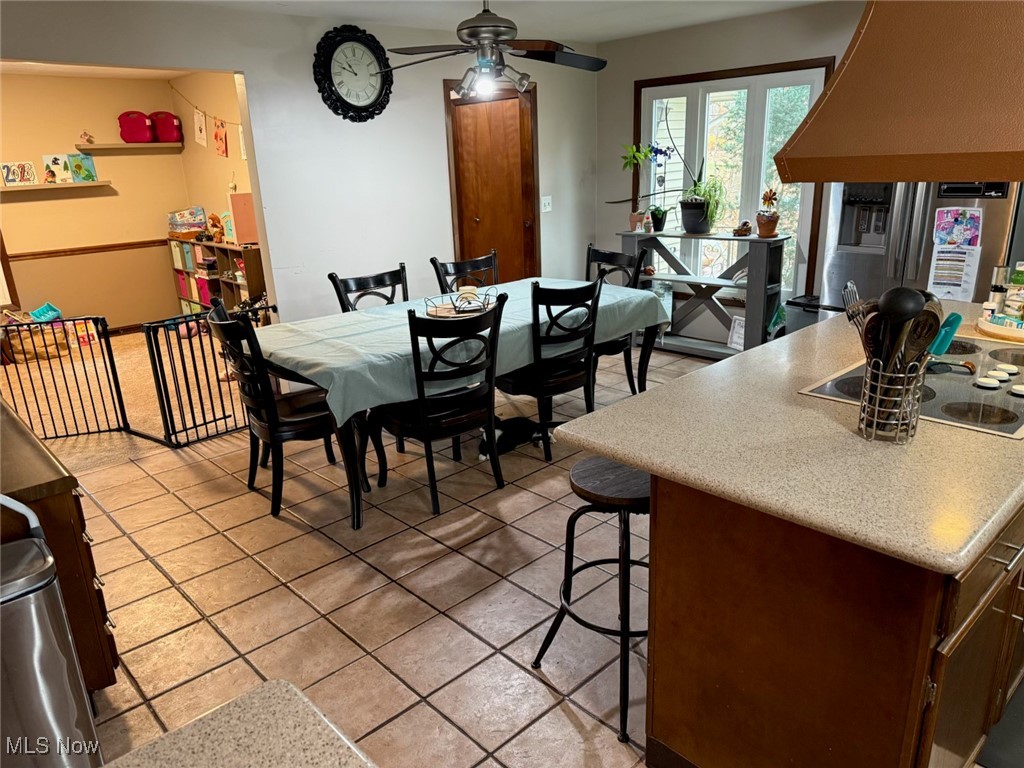 10719 Johnnycake Ridge Road Painesville, OH 44077 - Photo 8 of 21 Dining area with light tile patterned floors and ceiling fan