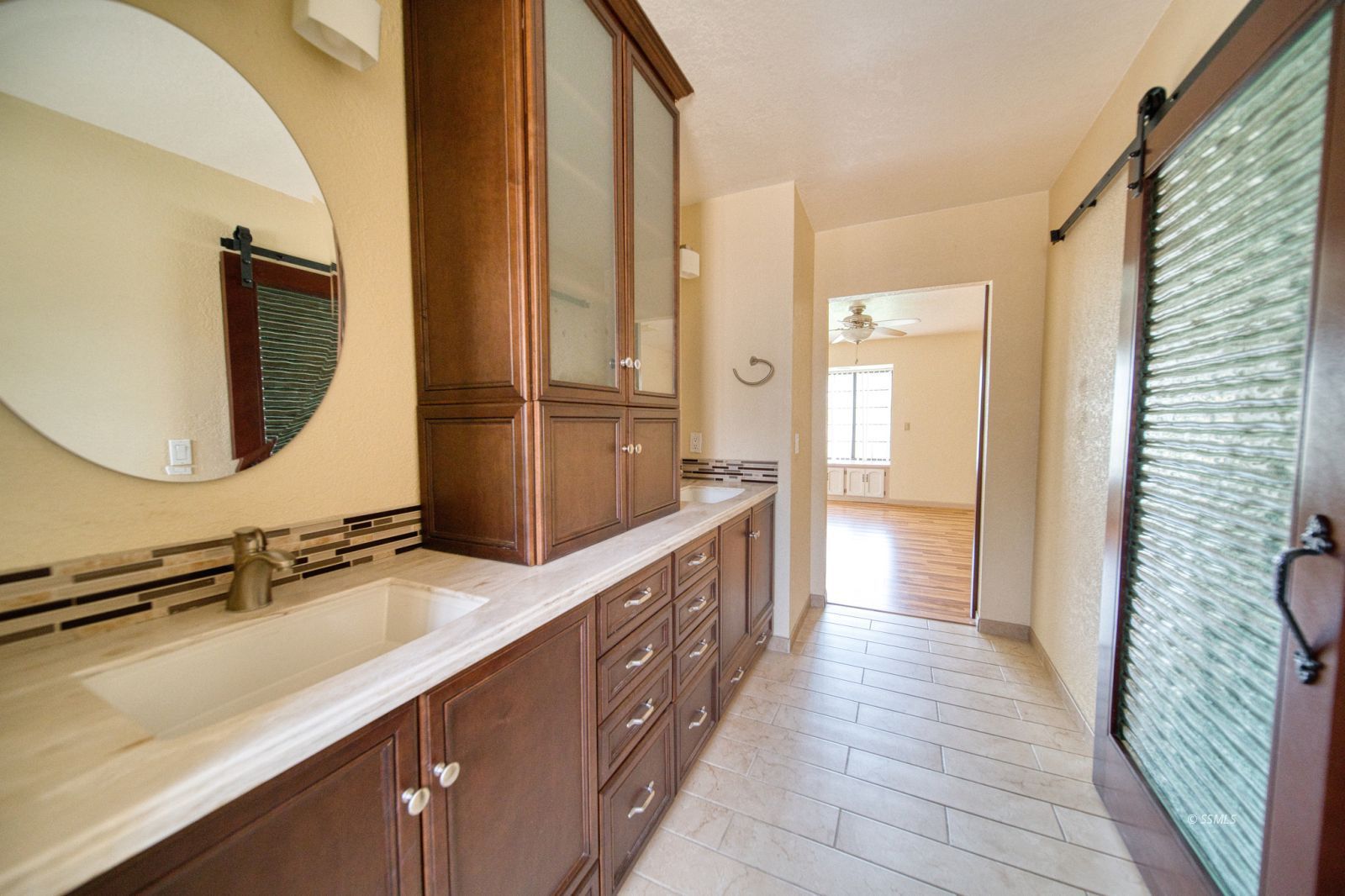1657 Autumn Avenue Ridgecrest, CA 93555 - Photo 28 of 36 a bathroom with a double vanity sink and a mirror