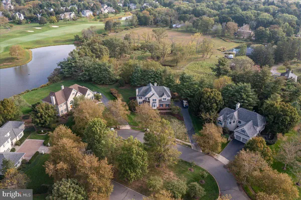 an aerial view of lake residential house with outdoor space and trees around
