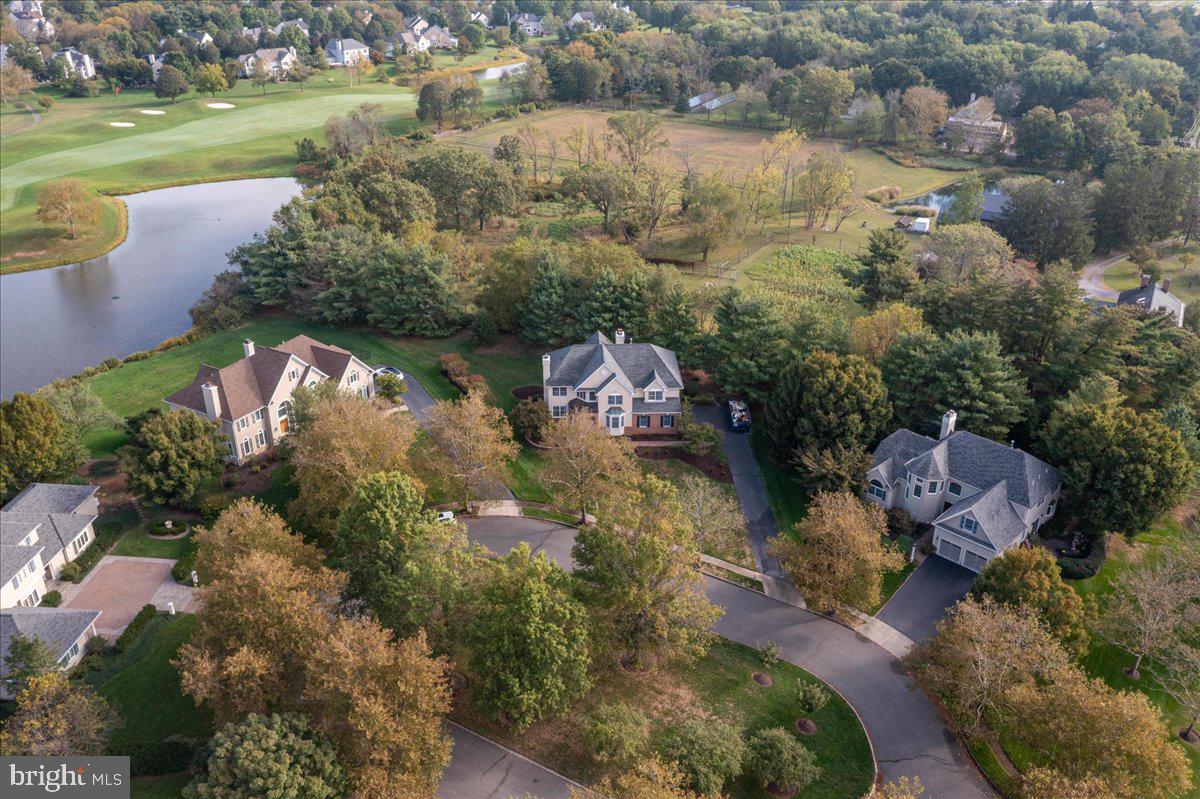 an aerial view of lake residential house with outdoor space and trees around