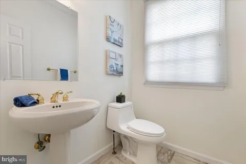 a bathroom with a sink mirror and toilet