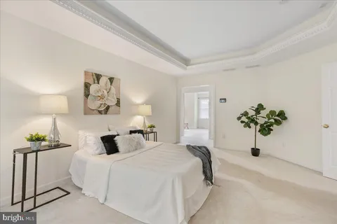 a bedroom with a bed and a lamp on table