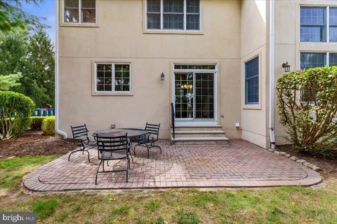 a view of a white house with a yard and plants