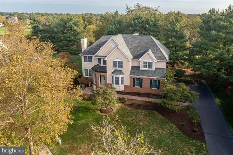 an aerial view of a house with a garden and lake view