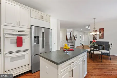a kitchen with stainless steel appliances a stove refrigerator and cabinets