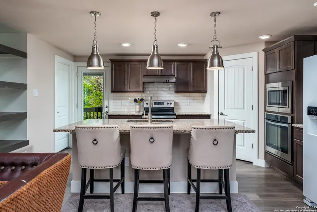 an empty room with wooden floor and window