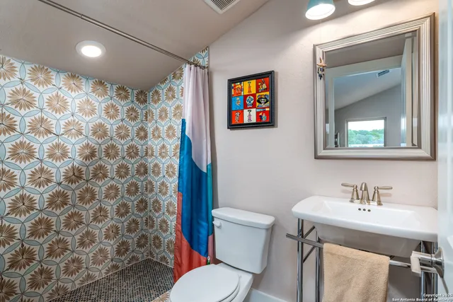 a view of empty room with wooden floor and iron stairs