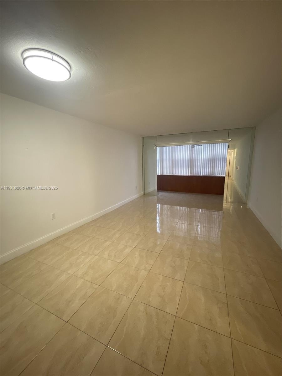 1305 West 46th Street, Unit 112 Hialeah, FL 33012 - Photo 6 of 11 an empty room with a empty space and windows