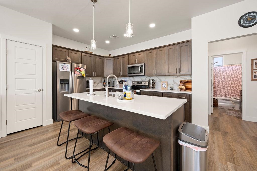1694 Tungsten Way Fruita, CO 81521 - Photo 10 of 22 a kitchen with a table chairs refrigerator and cabinets