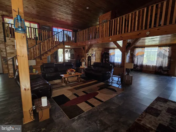 a kitchen with a stove and a wooden floor