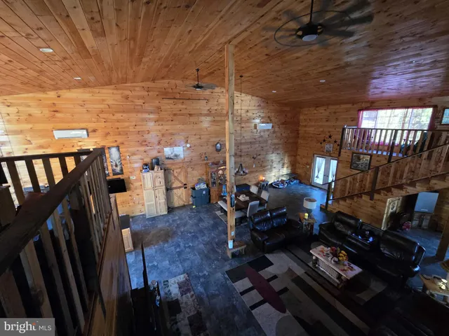 a living room with furniture a fireplace and wooden floor