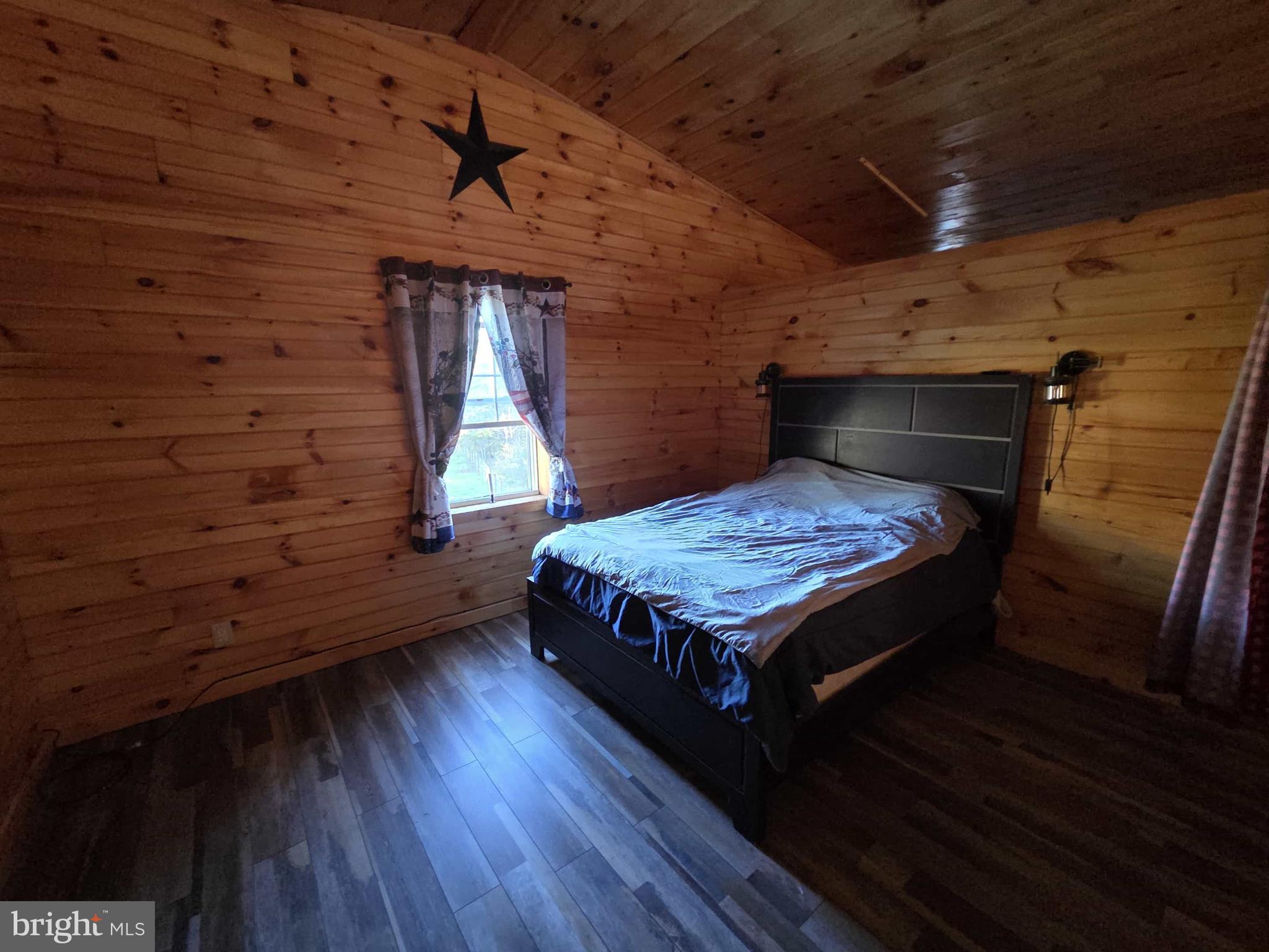 198 North Hunter Run Road Howard, PA 16841 - Photo 44 of 69 a bedroom with a bed and wooden floor