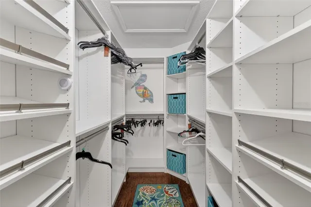a view of walk in closet with clothes and shoes
