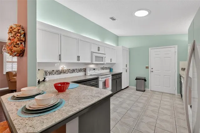 a kitchen with stainless steel appliances granite countertop a sink and cabinets