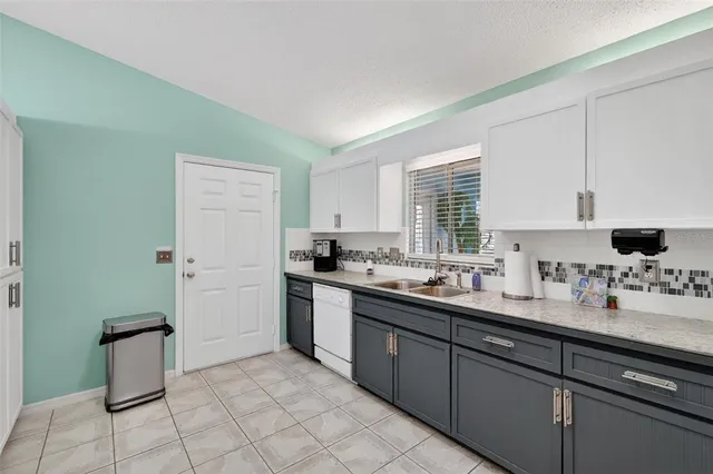 a kitchen with a sink cabinets and window