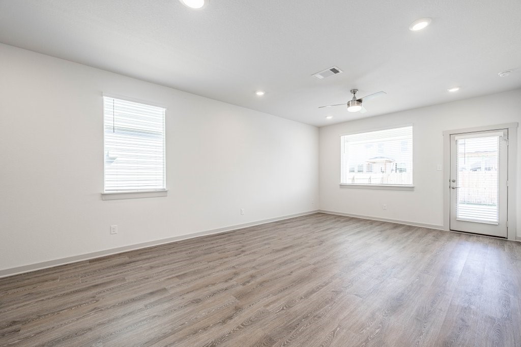 225 New Hampton Way San Marcos, TX 78666 - Photo 13 of 34 an empty room with wooden floor and windows