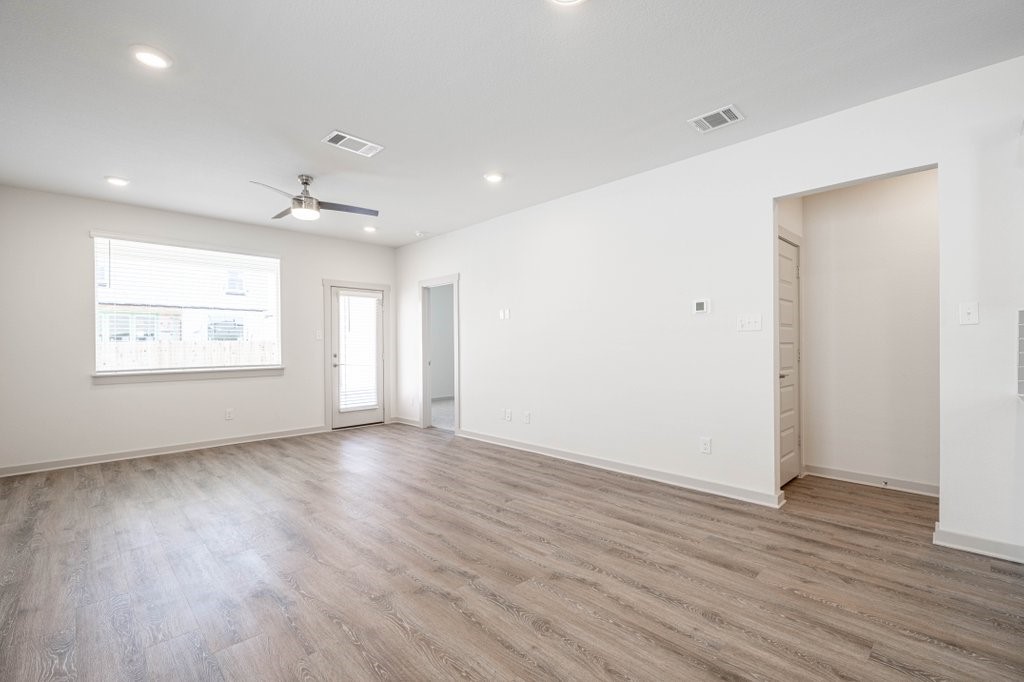 225 New Hampton Way San Marcos, TX 78666 - Photo 15 of 34 an empty room with wooden floor and windows