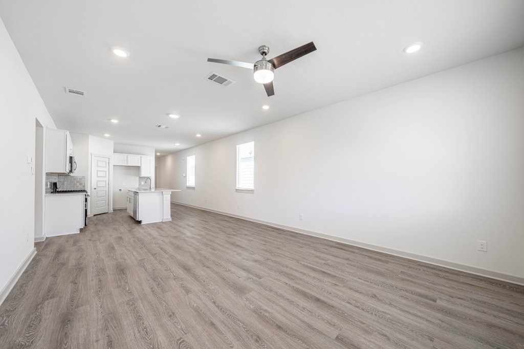 225 New Hampton Way San Marcos, TX 78666 - Photo 19 of 34 a view of an empty room with a window and wooden floor