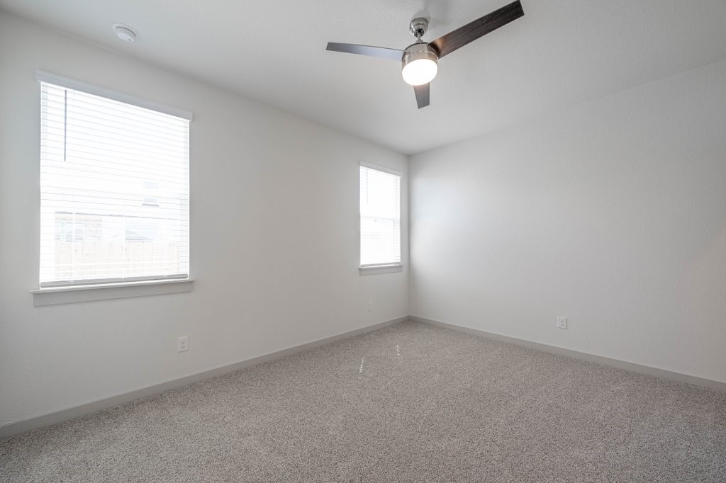 225 New Hampton Way San Marcos, TX 78666 - Photo 23 of 34 an empty room with a window and a fan