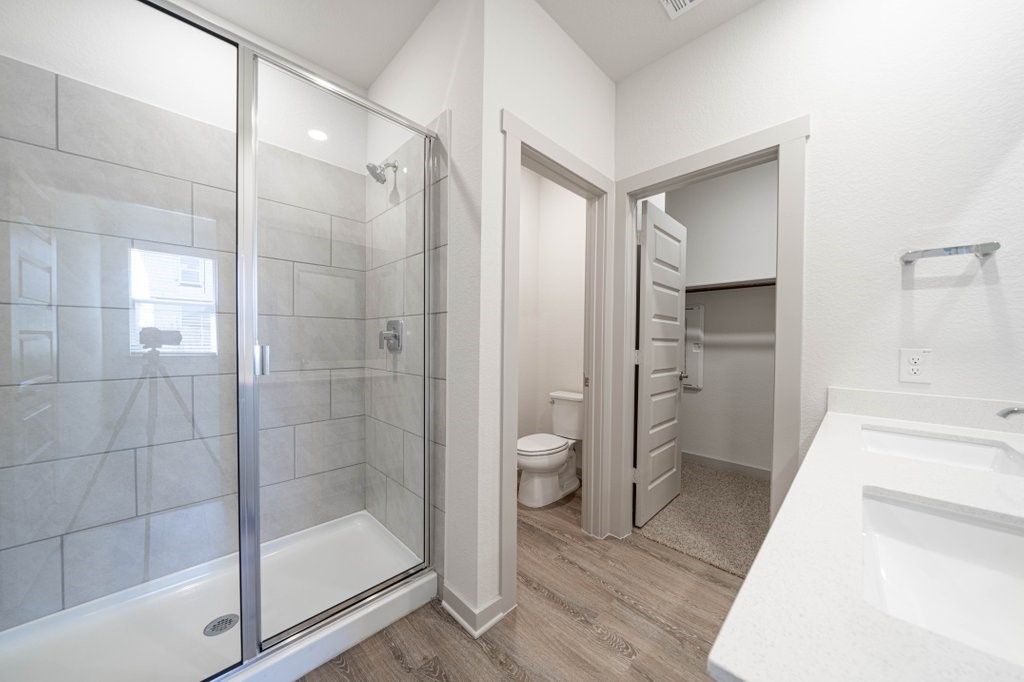 225 New Hampton Way San Marcos, TX 78666 - Photo 24 of 34 a bathroom with a glass shower door