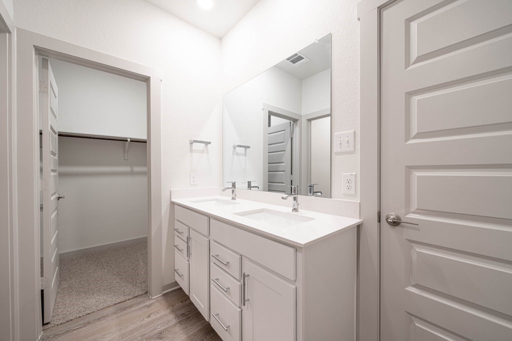 225 New Hampton Way San Marcos, TX 78666 - Photo 25 of 34 a bathroom with a double vanity sink and mirror