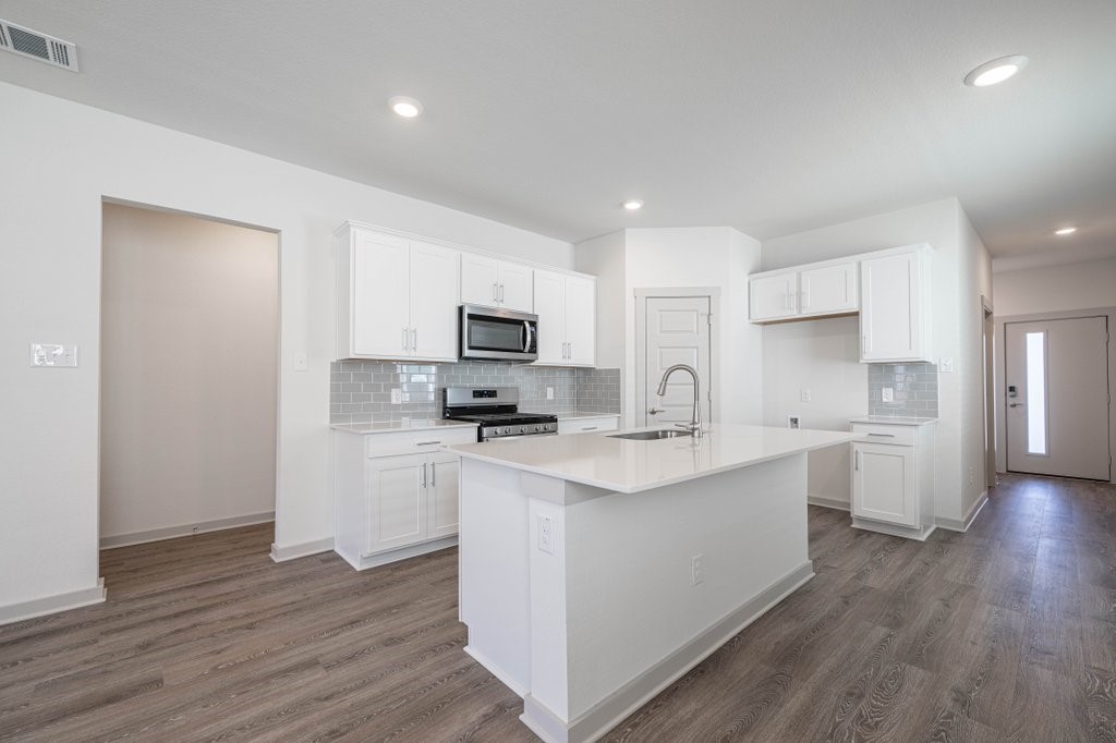 225 New Hampton Way San Marcos, TX 78666 - Photo 8 of 34 a kitchen with appliances a sink and cabinets