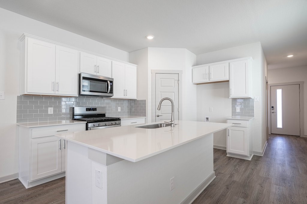 225 New Hampton Way San Marcos, TX 78666 - Photo 9 of 34 a kitchen with appliances a sink a stove a microwave and cabinets