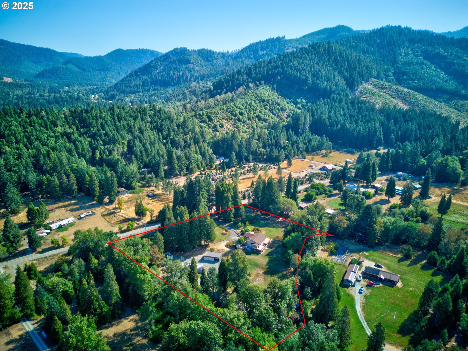 913 Starveout Creek Road Azalea, OR 97410 - Photo 26 of 27 an aerial view of a house with mountain view