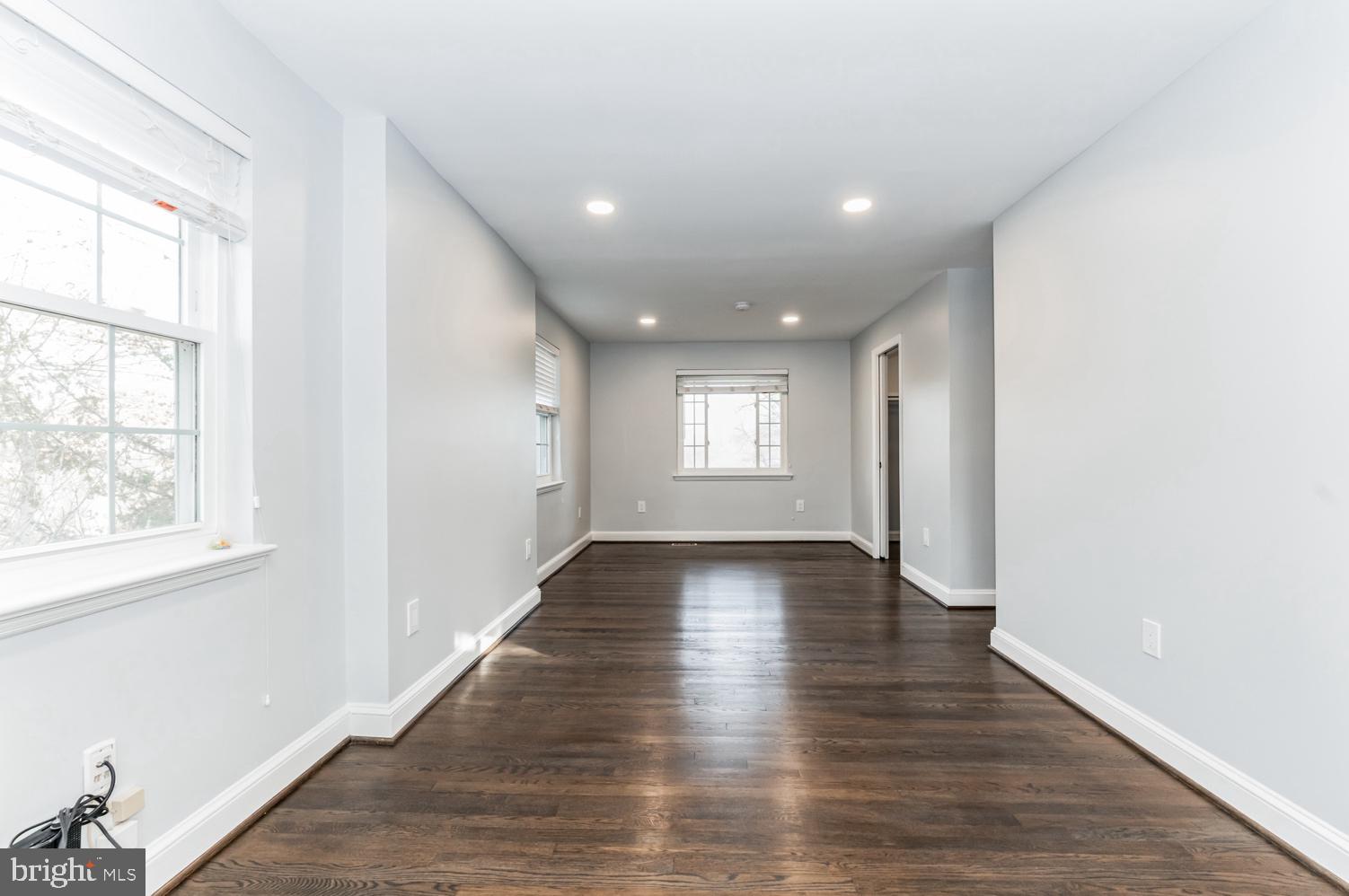 7016 Donna Circle Annandale, VA 22003 - Photo 11 of 30 a view of an empty room with wooden floor and windows
