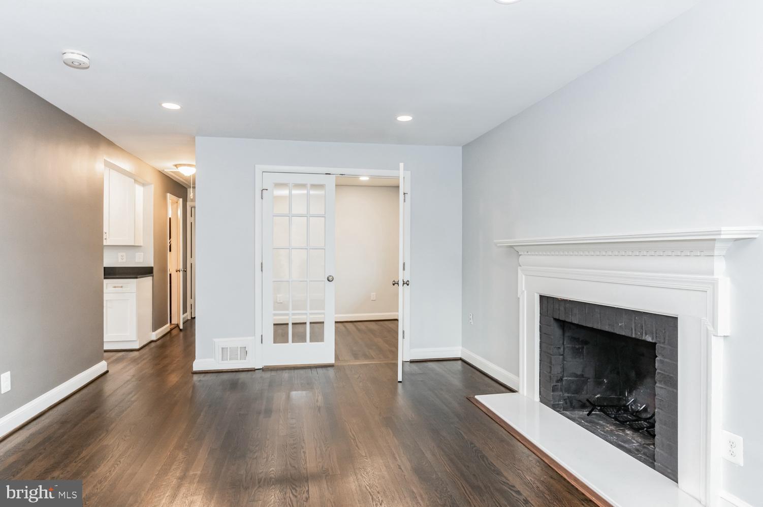 7016 Donna Circle Annandale, VA 22003 - Photo 3 of 30 a view of an empty room with wooden floor fireplace and a window