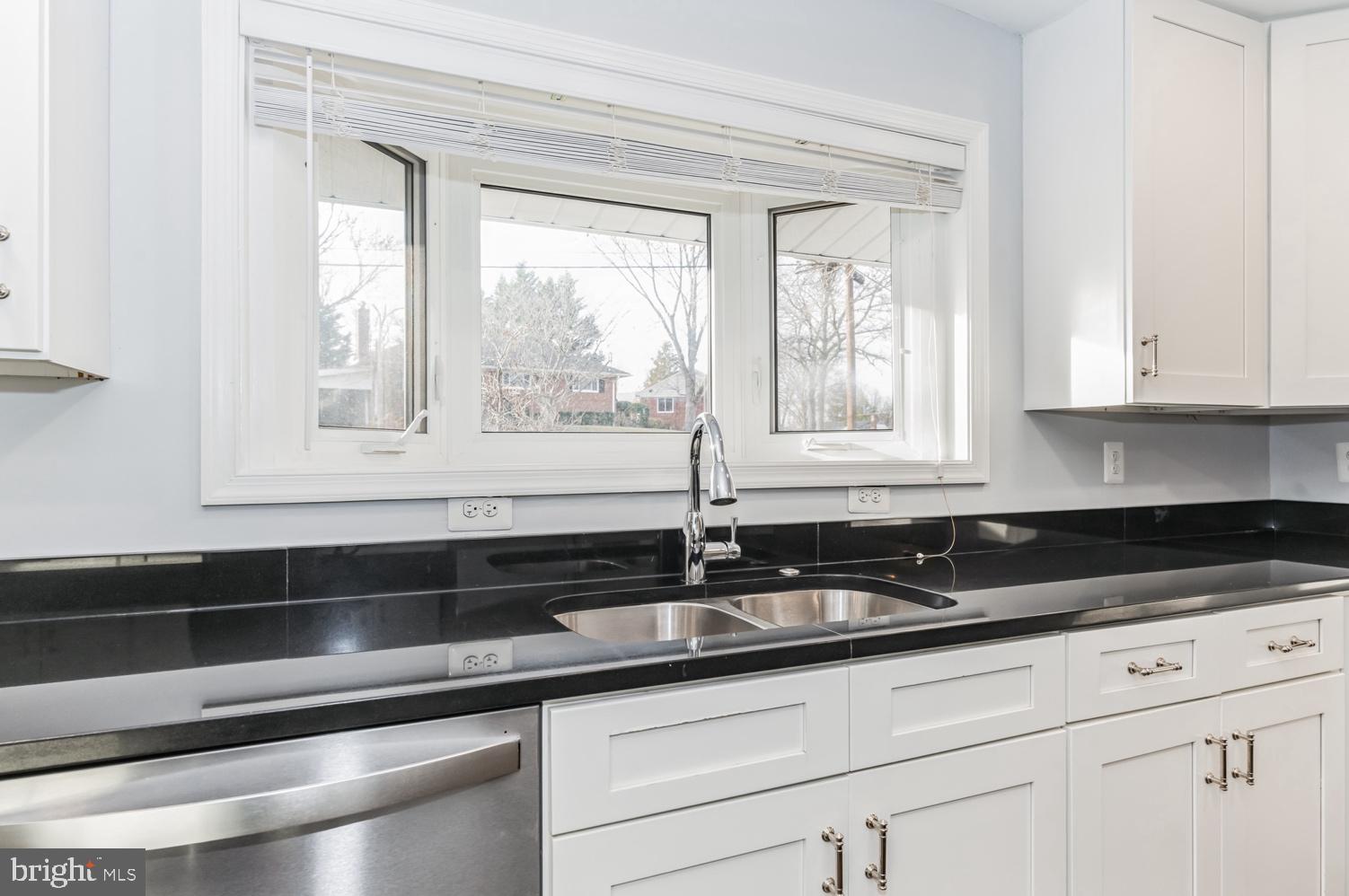 7016 Donna Circle Annandale, VA 22003 - Photo 8 of 30 a white kitchen with granite countertop white cabinets and window