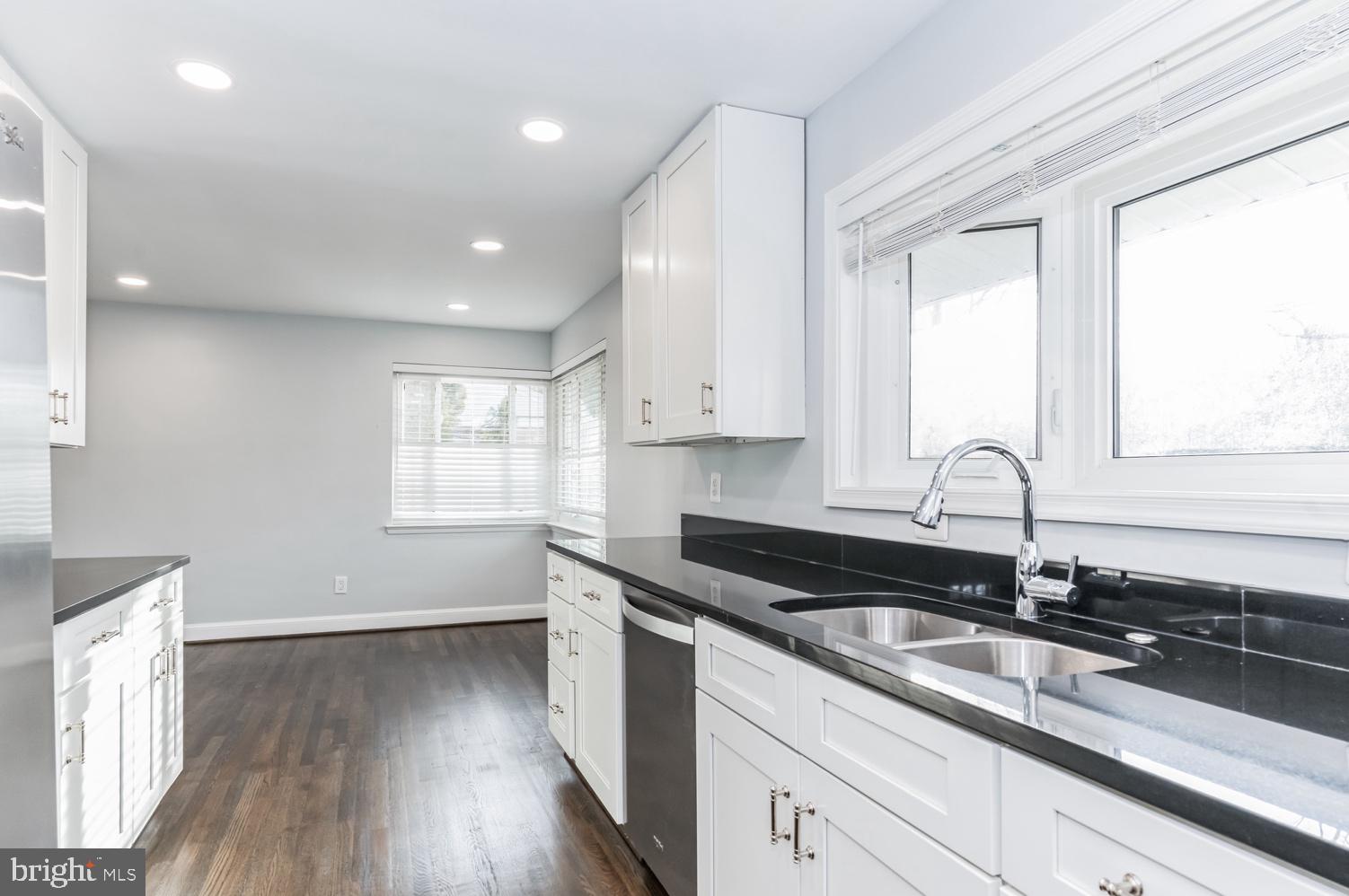 7016 Donna Circle Annandale, VA 22003 - Photo 9 of 30 a kitchen with granite countertop white cabinets white appliances and a large window