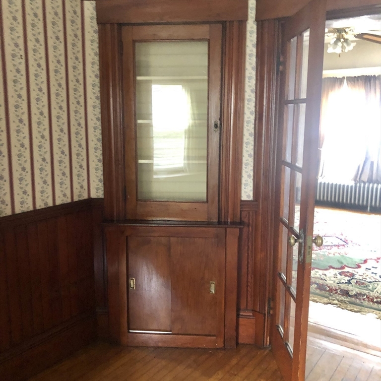 118 Chace Street Clinton, MA 01510 - Photo 27 of 41 a view of an empty room with wooden floor and a window