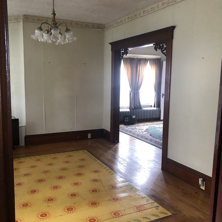 118 Chace Street Clinton, MA 01510 - Photo 33 of 41 a view of empty room with wooden floor