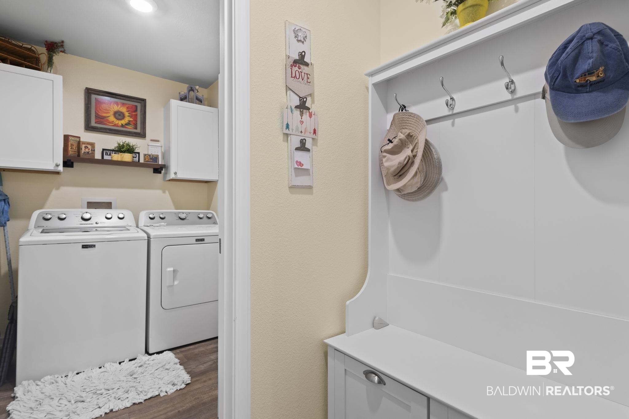345 Hartenstein Road Foley, AL 36535 - Photo 25 of 47 Laundry area with washing machine and dryer, cabinets, and dark hardwood / wood-style floors