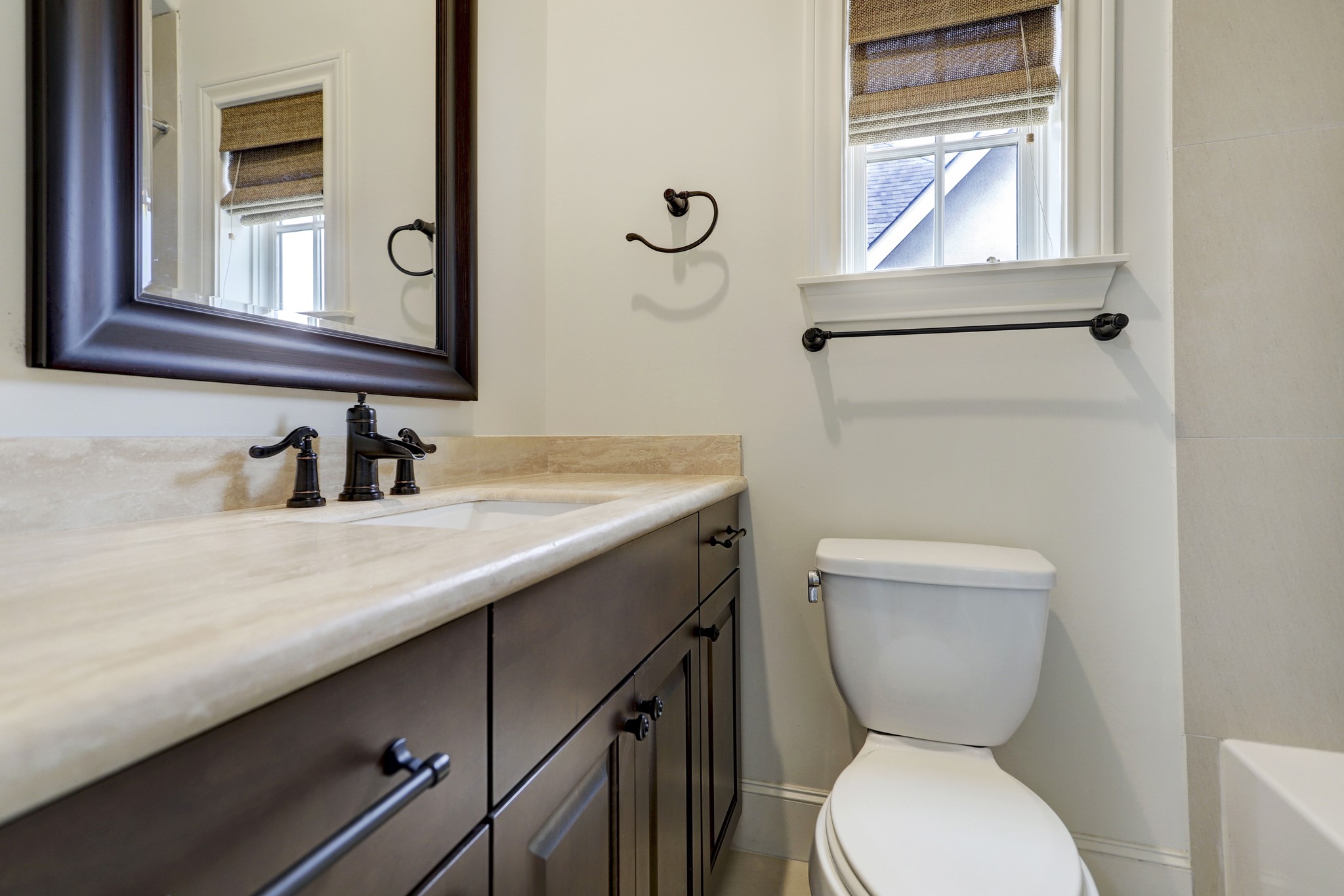 5218 Crawford Street Houston, TX 77004 - Photo 10 of 22 a bathroom with a toilet sink and mirror