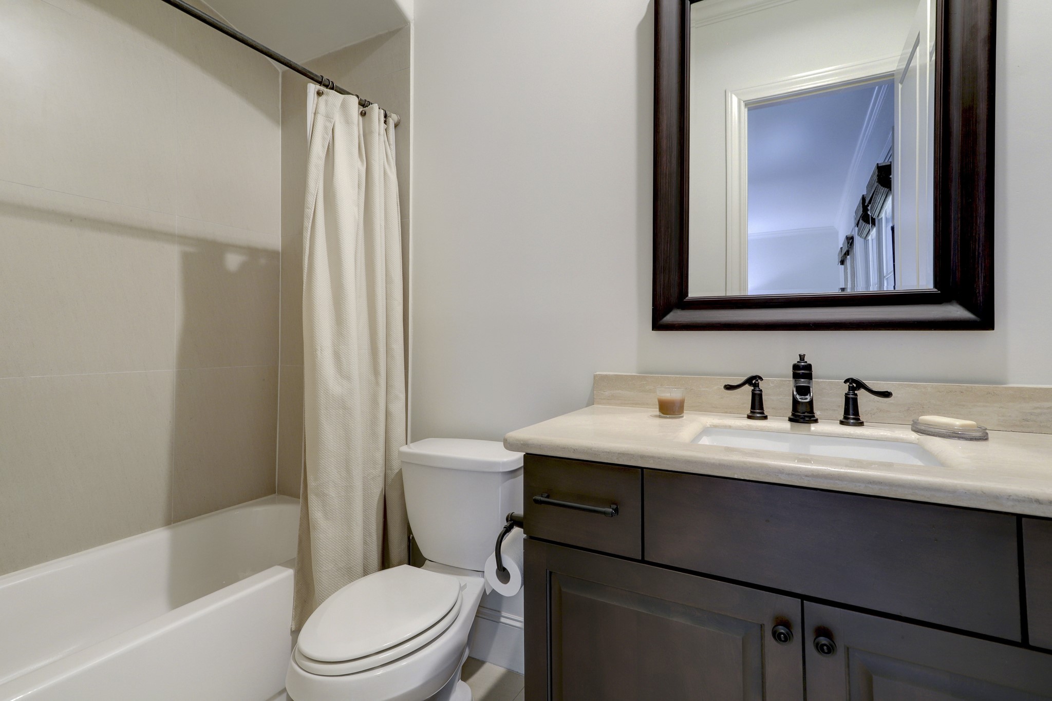 5218 Crawford Street Houston, TX 77004 - Photo 14 of 22 a bathroom with a toilet sink vanity tub and shower
