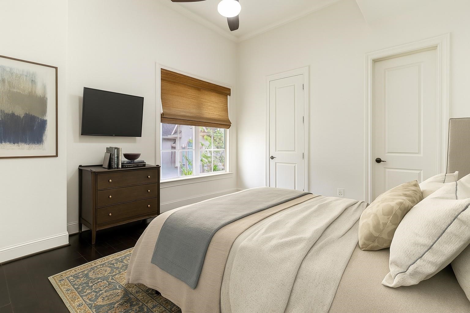 5218 Crawford Street Houston, TX 77004 - Photo 9 of 22 a bedroom with a bed and a flat screen tv