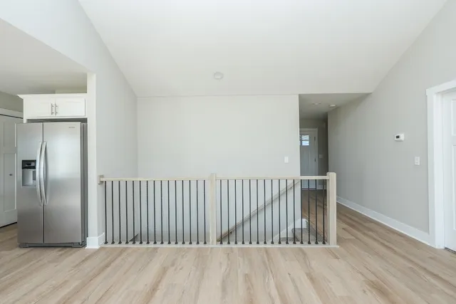 a large kitchen with kitchen island a sink a center island stainless steel appliances and a window