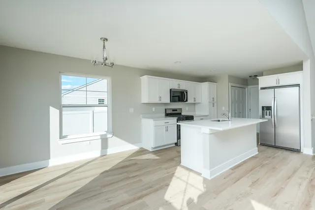 a kitchen with a stove a sink and a refrigerator