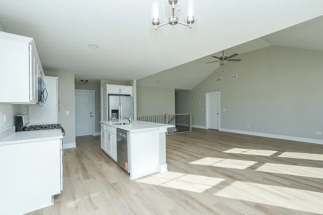 a kitchen with a sink a stove a microwave and cabinets