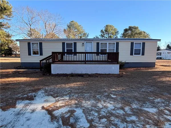 a view of a house with a yard and sitting area
