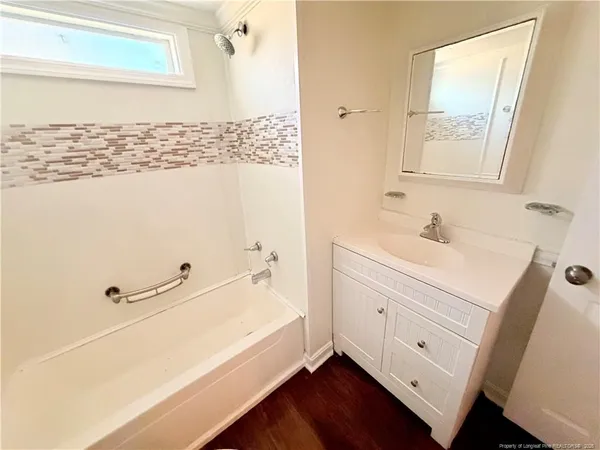 a bathroom with a bathtub and a sink