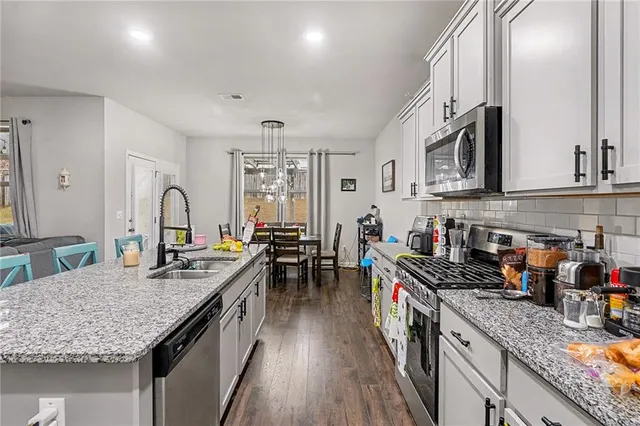 a kitchen with granite countertop lots of counter top space and stainless steel appliances