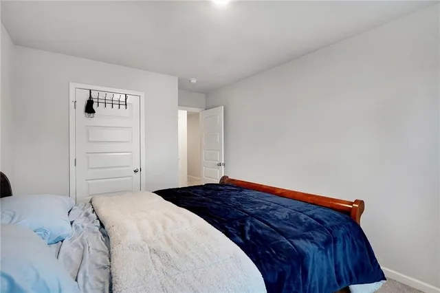 a bedroom with a bed and cabinet