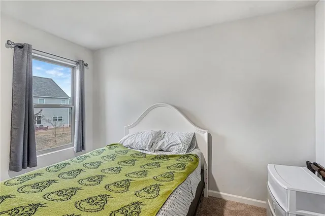 a bedroom with a bed and with a mirror